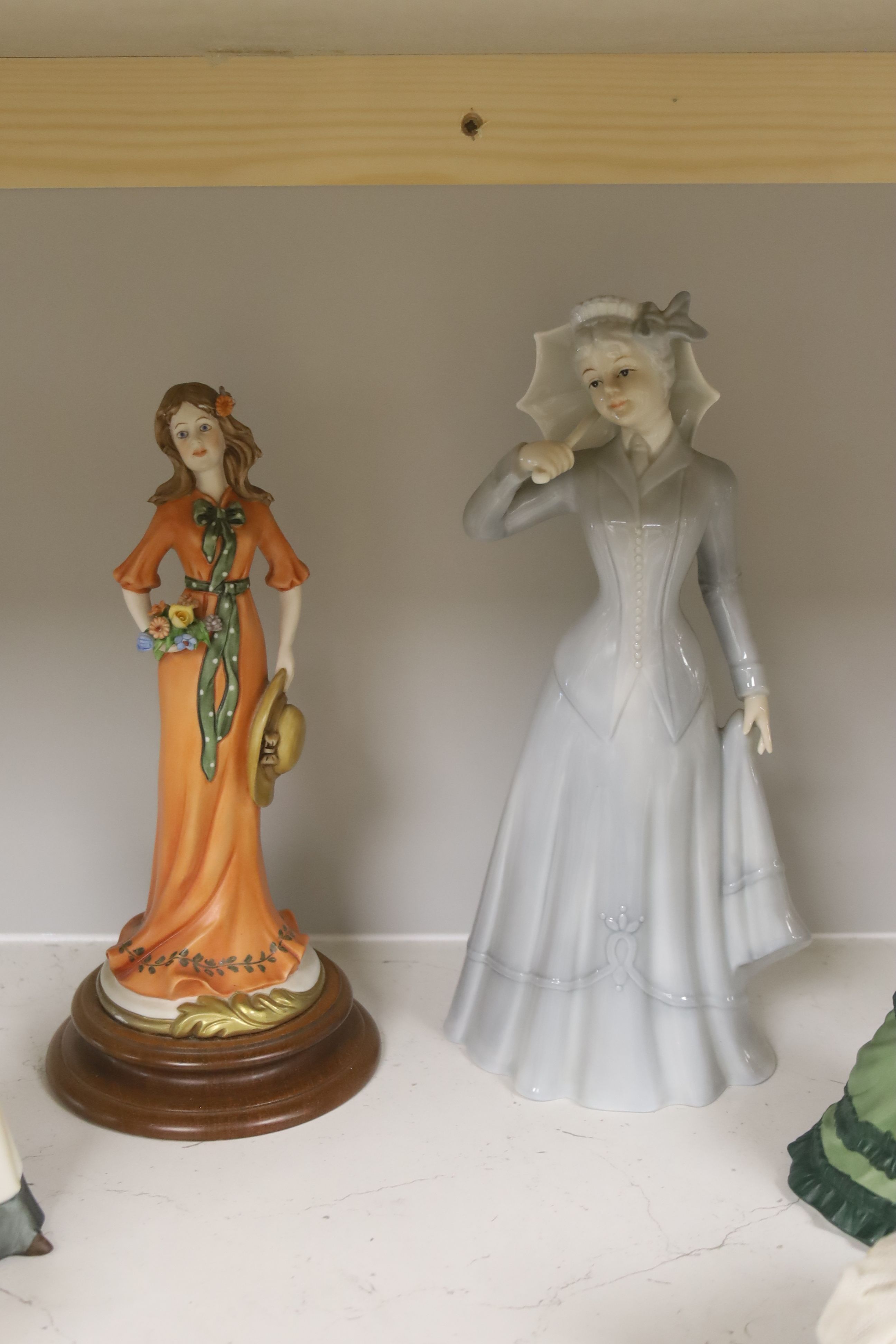A German porcelain group of two children by a tree stump, on rocky base, two 'crinoline' figures and six other porcelain groups
